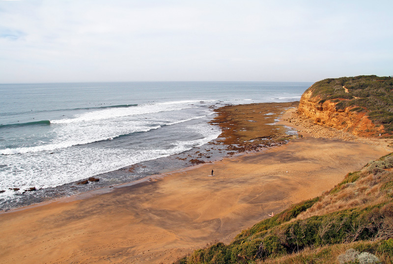 Surfers on Bells Beach, Victoria, Australia