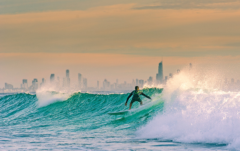 A morning surf on the Gold Coast. Sunrise near Snapper Rocks with Surfers Paradise in the background