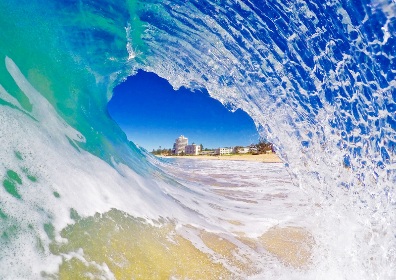 view from surfing under a cresting wave at Northern Beaches near Sydney, Australia